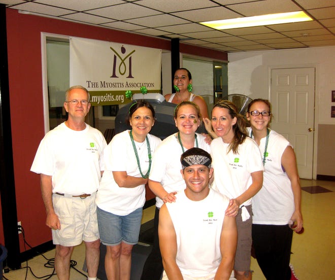 Standing from left are Matthew Sullivan III, Joyce Sullivan, Beth Trout, Kathy Tierney and Jackie Stark, with Tom Fisher kneeling, as Lisa Faria, in back, runs her half-hour shift on the treadmill to help raise money and awareness for The Myositis Association.