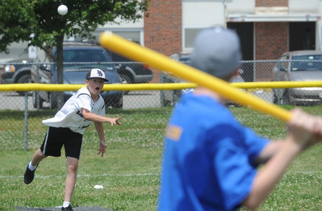 Sam Hendrigan, 12, of Brockton, left, delivers a pitch during a game in the 20th annual Wiffle Rock Wiffleball tourney in Stoughton on Saturday, June 23, 2012.