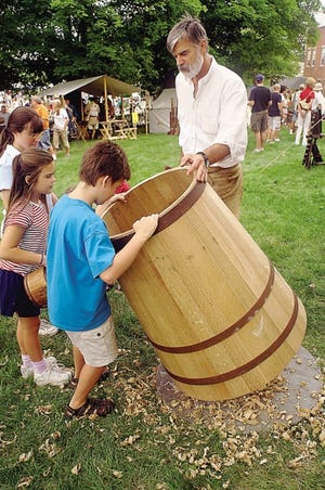 Cooper Ron Raiselis shows kids the Colonial trade.