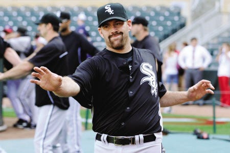New Chicago White Sox third baseman Kevin Youkilis stretches during warmups prior to Monday’s game against the Minnesota Twins. Youkilis went 1-for-4 in his debut with his new team.