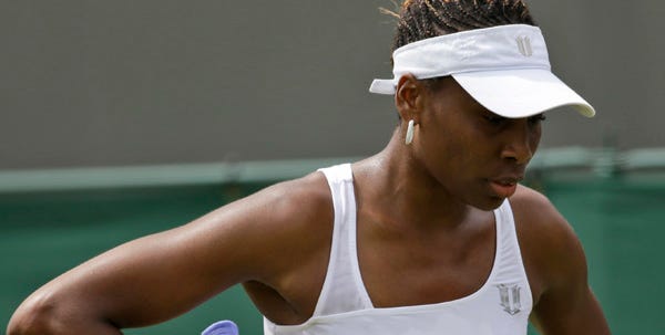 Venus Williams reacts after losing a point during her first-round loss to Elena Vesnina at Wimbledon on Monday.