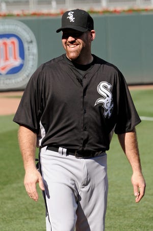 New Chicago White Sox third baseman Kevin Youkilis smiles during warmups before Monday night’s game against the Minnesota Twins.