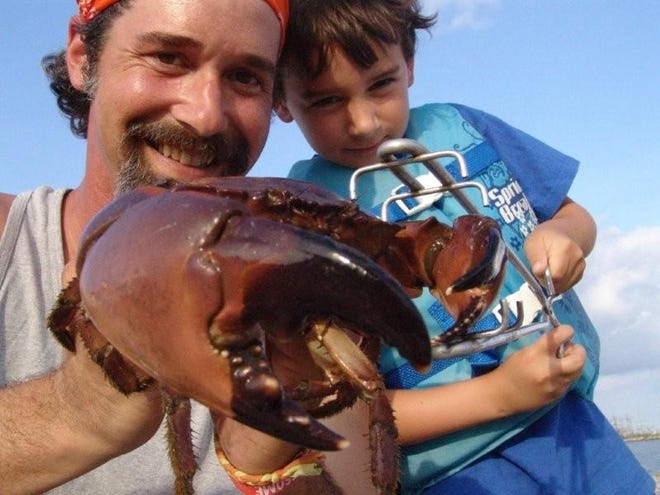 Brent and Ned Hammatts, of Galvez, show off their monster crab caught on a recent trip to Leeville. Mom. Kory was along also.