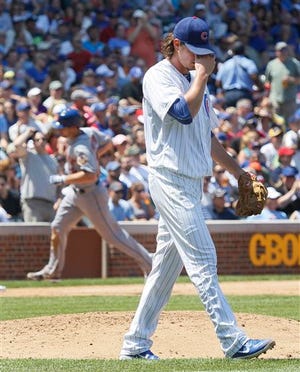 Chicago Cubs starting pitcher Jeff Samardzija reacts after giving up a two-run home run to New York Mets' Daniel Murphy, background, also scoring Ike Davis, during the fourth inning of a baseball game, Wednesday, June 27 2012, in Chicago. (AP Photo/Charles Rex Arbogast)