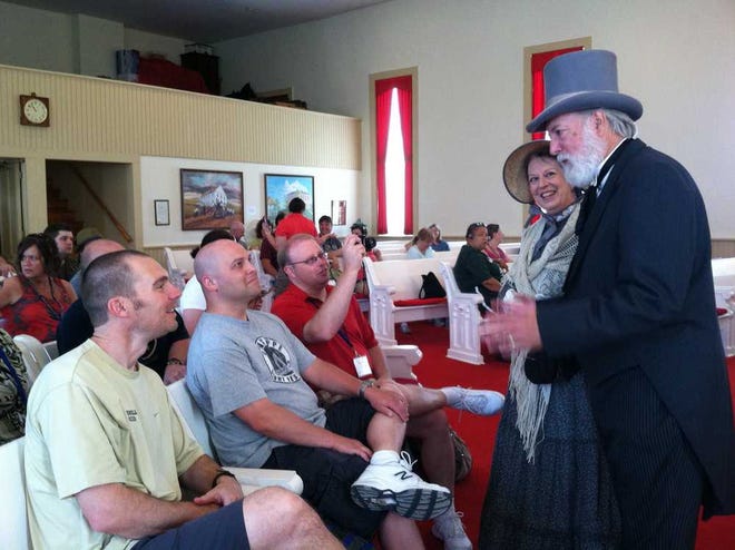 Steve and Suzanne Germes, of Topeka, portraying Kansas Gov. Charles Robinson and his wife, Sara, talk to participants in the "Crossroads of Conflict: Contested Visions of Freedom and the Missouri-Kansas Border Wars" conference that met Wednesday at the Territorial Capital Museum in Lecompton. The Germeses were among the amateur actor-historians who portrayed historical figures during a presentation of "Bleeding Kansas," a play by Lecompton resident Howard Duncan.