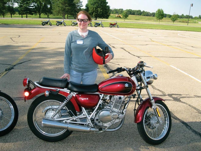Jeanette Kendall of Washington stands next to the Suzuki she rode in the motorcycle safety class at Illinois Central College June 9.