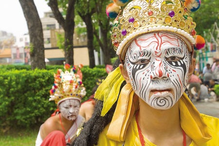 Young men don the face paint and attire of spiritual generals during a rare celebration for the city God of Chiayi, Taiwan. Over three days at the beginning of September 2011, a massive parade weaves through the city past each temple entertaining the crowds with dancing, singing, drumming, and fireworks to wake the gods. Courtesy photo by Jeremy Heflin