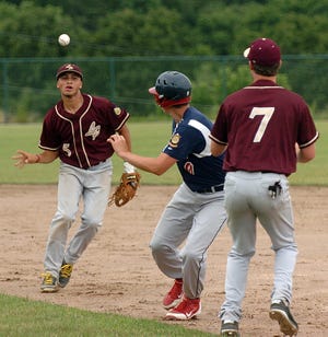 Moosup’s Gage Griffin is caught in a rundown between Ledyard-Pawcatuck’s Isiah Cruz, left, and Luke Foster on Wednesday during Senior American Legion play in Plainfield.