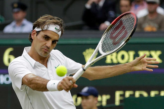 Roger Federer of Switzerland returns a shot to Julien Benneteau of France during a third round men's singles match at the All England Lawn Tennis Championships at Wimbledon, England, Friday, June 29, 2012. (AP Photo/Alastair Grant)