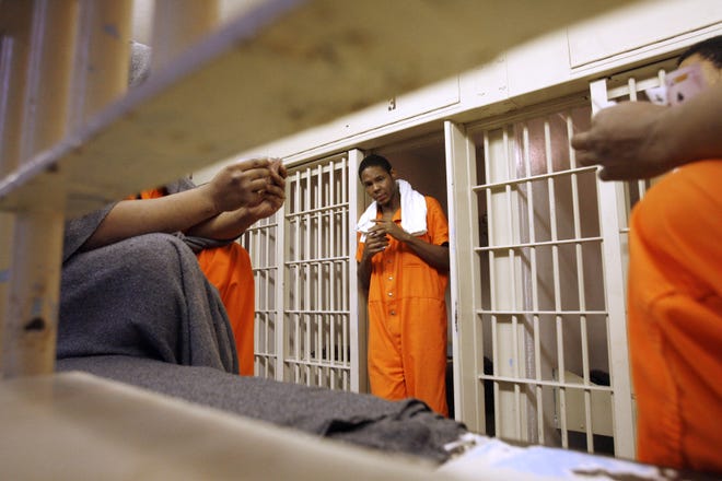 Male inmates play cards in the Stark County Jail.