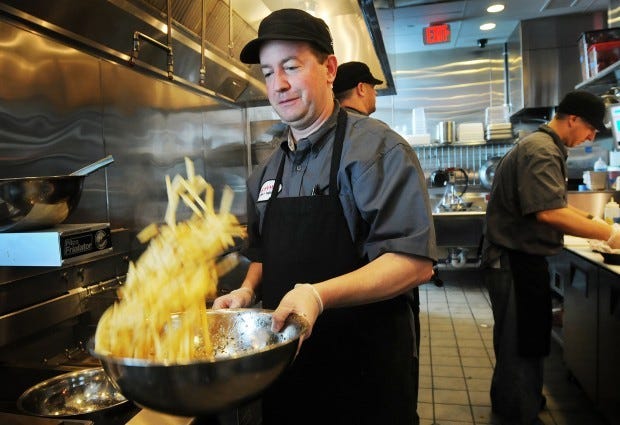 Chef Joe Muth tosses fresh fries in parmesan cheese and rosemary.