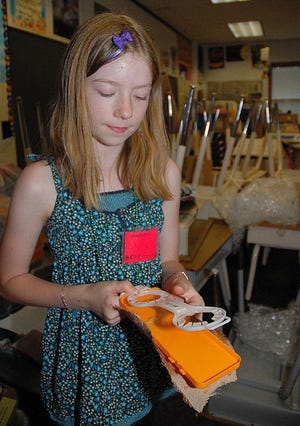 Dalyn Newsom, 10, tests her "Note Launcher" that she created at Camp Invention at Resica Elementary School. Students created a variety of devices from recycled materials that correspond to Pennsylvania state standards in science, such as concepts in force and motion.