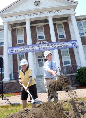 Somerset High Class of 1938 member Beatrice Parrot joins Somerset-Berkley High School Class of 2012 member in some ceremonial dirt-tossing for the new somerset berkly High School, during ceremonies held Friday.