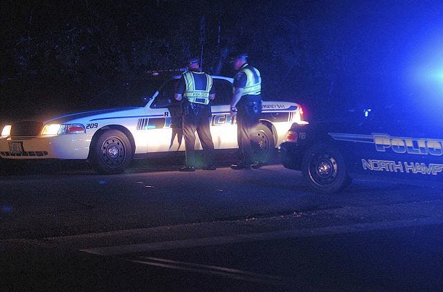John Huff/Staff photographer 
North Hampton Police block off one end of Brackett Road in Rye as SERT police attempt to get a man held up in his home with a weapon to surrender Friday evening.