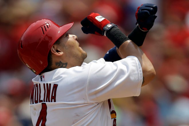St. Louis Cardinals catcher Yadier Molina celebrates as he reaches home after hitting a solo home run during the second inning of Sunday's game against the Pittsburgh Pirates.