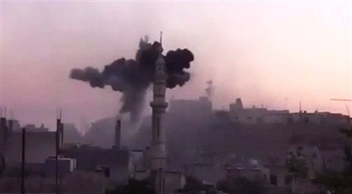 In this image made from amateur video released by the Ugarit News and accessed Monday, July 2, 2012, black smoke leaps the air from shelling near Ali bin Abi Taleb mosque in Talbiseh, the central province of Homs, Syria. The head of the Arab League urged Syria's exiled opposition to unite Monday, saying they must not squander the opportunity to overcome their differences as Western efforts to force President Bashar Assad from power all but collapse. (AP Photo/Ugarit News via AP video)