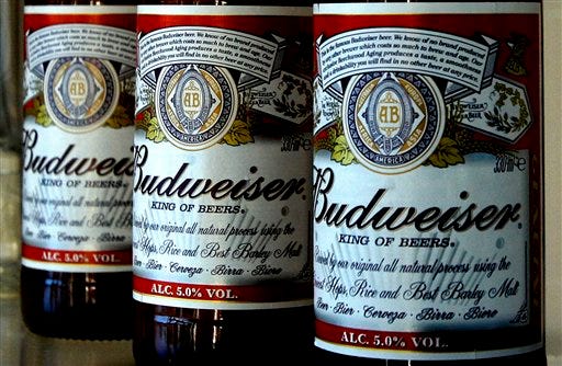 In this Jan. 27, 2009 file photo, bottles of Budweiser beer are seen at the Stag Brewery in London. (AP Photo/Kirsty Wigglesworth, File)