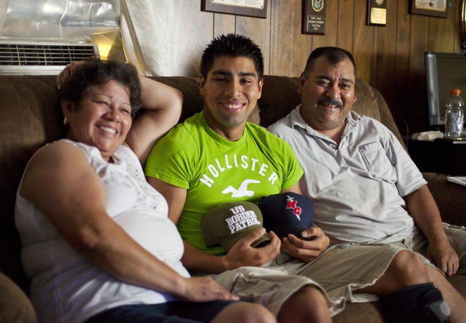 Jose Luna, 19, shown with his mother and father, Maria and Emilio, in their Beardstown home, is heading to MacMurray College in fall 2012 to double major in homeland security and criminal justice. Justin L. Fowler/The State Journal-Register