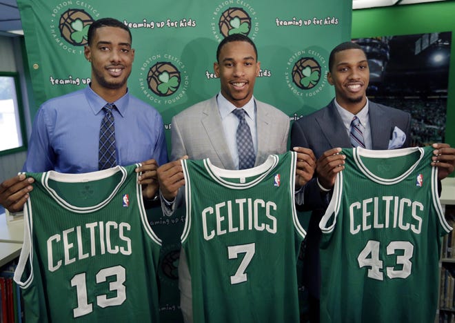 Celtics 2012 draft picks, from left, center Fab Melo and forwards Jared Sullinger and Kris Joseph hold up their jerseys during an introductory news conference in Boston on Monday.