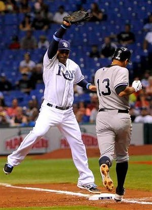 Tampa Bay Rays first baseman Carlos Pena, left, gets the out at first base on New York Yankees' Alex Rodriguez to end the top of the fifth inning of a baseball game, Monday, July 2, 2012, in St. Petersburg, Fla. (AP Photo/Brian Blanco)