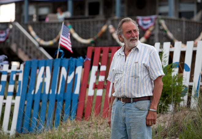 Humarock, MA 07/01/2012Humarock resident Bob Graci stands in front of his display of red, white and blue wooden pallets that he was ordered to remove outside his home on Central Avenue on Sunday, July 1, 2012.