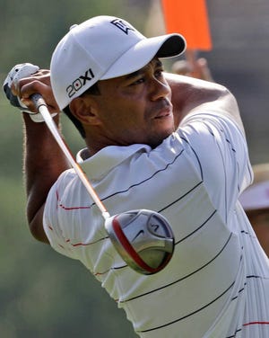 Tiger Woods watches his tee shot on the 11th hole during the ProAm of the Greenbrier Classic PGA Golf tournament at the Greenbrier in White Sulphur Springs, W. Va., Wednesday, July 4, 2012. (AP Photo/Steve Helber)