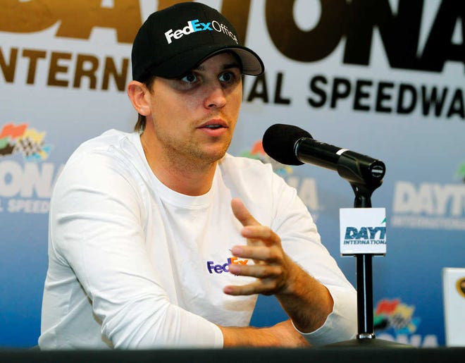 Denny Hamlin answers questions during a news conference after a practice session for the NASCAR Sprint Cup Series Coke Zero 400 auto race at Daytona International Speedway, Thursday, July 5, 2012, in Daytona Beach, Fla. Hamlin was unable to practice because of an injury. (AP Photo/Terry Renna)