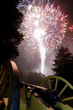 A 1781 Yorktown cannon used in the Revolutionary War and the War of 1812, owned by Roger Stark of Louisville, is lit by fireworks following the concert by The United States Army Field Band 
at the McKinley National Memorial. This and other cannons were fired during the 1812 Overture.