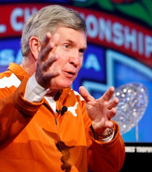 ** CORRECTS SECOND TEAM MENTIONED TO ALABAMA ** Texas head coach Mack Brown speaks as the BCS Coaches' Trophy is displayed nearby during a news conference, Saturday, Jan. 2, 2010, in Anaheim, Calif., ahead of their BCS Championship NCAA college football game against Alabama. The game is scheduled for Thursday, Jan. 7. (AP Photo/Mark J. Terrill)