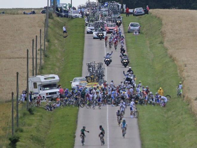 Riders try and get back on their bicycles after crashing at some 25 kilometers from the finnish line during the sixth stage of the Tour de France cycling race over 207.5 kilometers (129 miles) with start in Epernay and finish in Metz, France, Friday July 6, 2012.