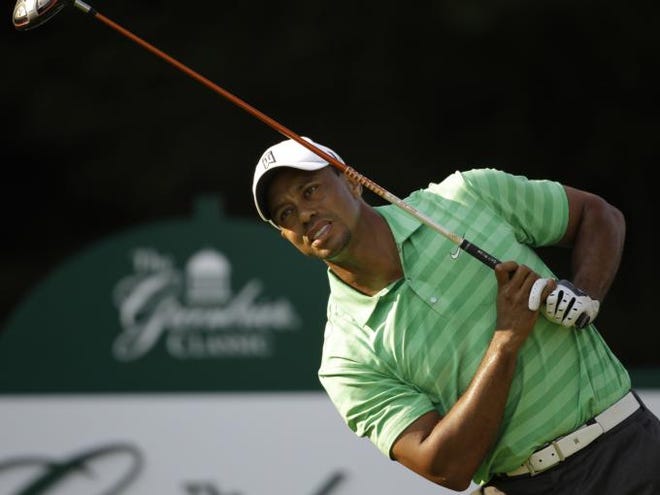 Tiger Woods reacts to his tee shot on the 12th hole during the second round of the Greenbrier Classic PGA Golf tournament at the Greenbrier in White Sulphur Springs, W. Va., Friday, July 6, 2012.