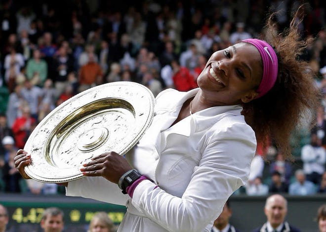 Serena Williams poses with her trophy after defeating Agnieszka Radwanska in the women's singles final on Saturday at Wimbledon.