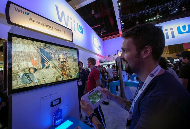 Nicolas Duclos, developer with Ubisoft Entertainment showcases the new "Assassin's Creed III" video game on the Nintendo Wii U console in Los Angeles Tuesday, June 5, 2012.The Electronic Entertainment Expo (E3), the premier convention for the computer and video game industry, is returning once again to Los Angeles for its annual gathering from June 5-7. (AP Photo/Damian Dovarganes)