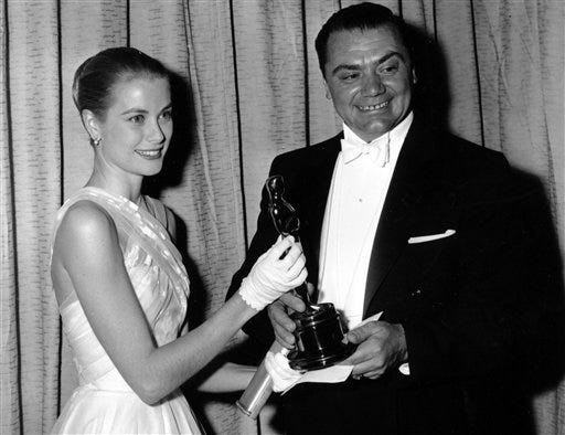 FILE - In this March 21, 1956, file photo, award presenter Grace Kelly poses with Oscar-winner Ernest Borgnine at the 28th Academy Awards in Hollywood, Calif., where Borgnine won best actor for his role in "Marty." A spokesman said Sunday, July 8, 2012, that Borgnine has died at the age of 95. (AP Photo/File)
