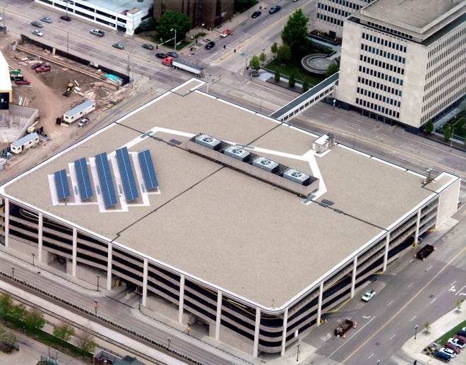 Photovoltaic panels on top of the Caterpillar Inc., parking garage in downtown Peoria will help power the Caterpillar Visitor's Center when it opens in October. Solar energy is one of several "green" elements of design in the center and in the adjacent Peoria Riverfront Museum.