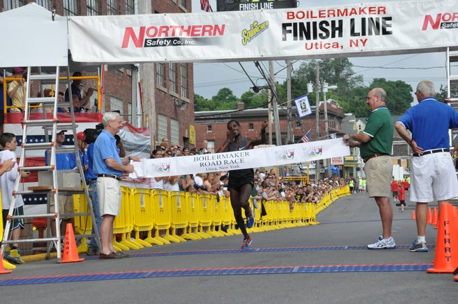 Winner Tilahun Regassa, of Ethiopia, crosses the finish line at the 35th annual Boilermaker Road Race with an unofficial time of 43:00 on July 8, 2012
