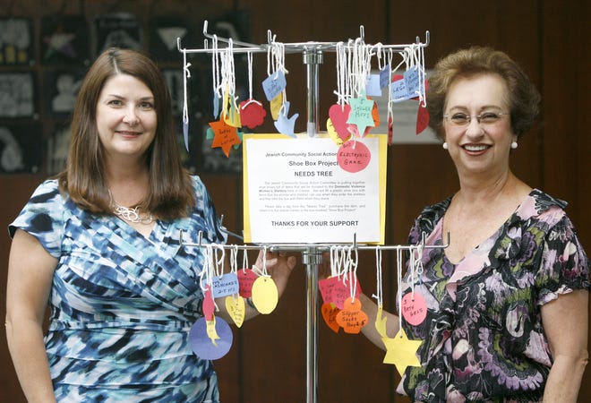 Judy Tenenbaum is shown with Diana Collum by the Giving Tree at the Canton Jewish Community Center.