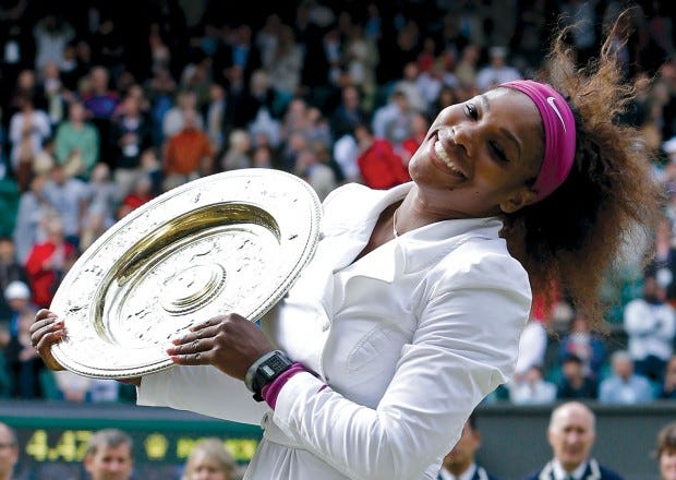 Serena Williams is the Centre of attention at Wimbledon on Saturday after defeating Agnieszka Radwanska in the women's final. (AP PHOTO/KIRSTY WIGGLESWORTH)