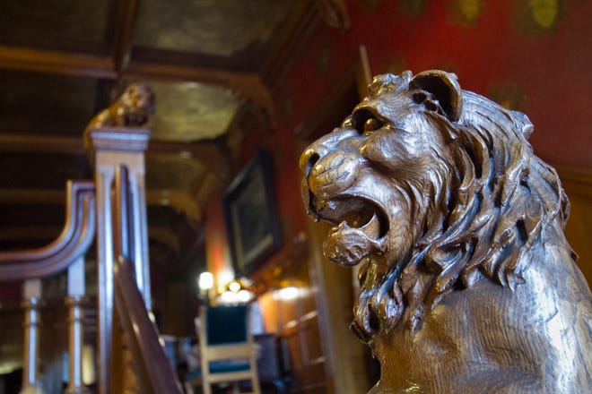 An ornate lion flanks the stairwell in the historic Five Oaks home.