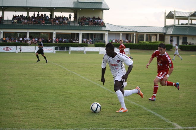Stampede striker Anthony Asante works the ball upfield.