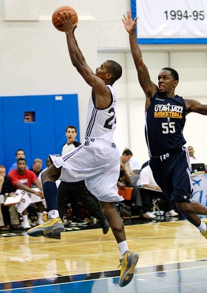 Detroit’s Kim English, left, drives to the basket past Utah’s Kevin Murphy (55) during an NBA summer league basketball game Monday in Orlando, Fla. English finished with 18 points.