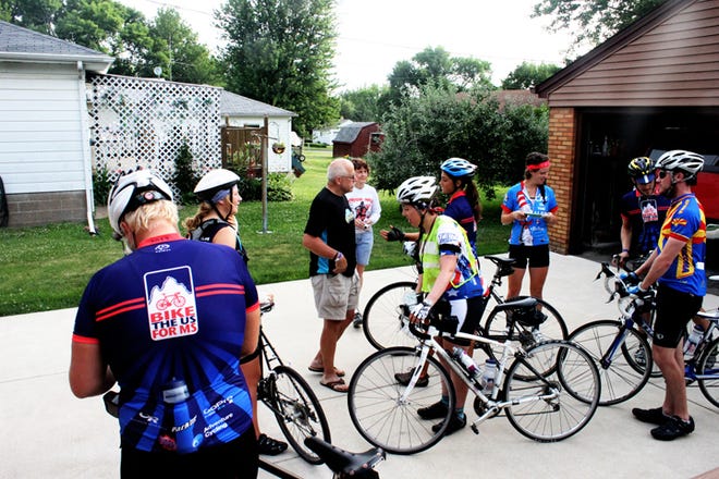 Rich and Debbie Straub, in back, say goodbye to some of the 13 Bike the US for MS riders preparing to leave their home in Orion following breakfast on Saturday, June 23.