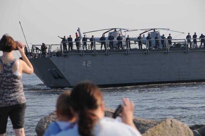 A Sailor aboard USS Klakring (FFG 42) waves farewell to his family as the ship leaves Naval Station Mayport, Fla., on June 29 for a deployment to the Caribbean Sea and eastern coast of South America to participate in Intelligence Surveillance Reconnaissance operations.