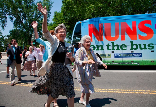 Sister Simone Campbell, left, and Sister Diane Donoghue lead the way as the the "Nuns on the Bus" arrive on Capitol Hill in Washington, Monday, July 2, 2012, after a nine-state tour to bring stories of hardship to Congress. Campbell is executive director of Network, a liberal Catholic social justice lobby in Washington. (AP Photo/J. Scott Applewhite)