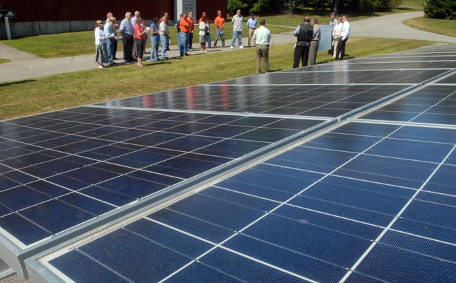 A small group of people attends the formal ribbon-cutting of Windham Water Works’ 100-kilowatt-hour solar array project.