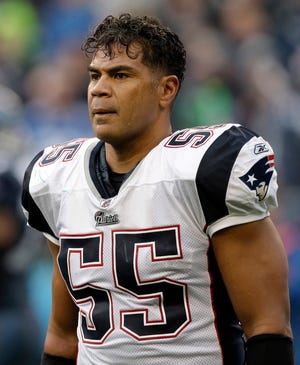 FILE - In this Dec. 7, 2008, file photo, New England Patriots' Junior Seau watches during an NFL football game against the Seattle Seahawks in Seattle. Brain tissue from Seau, the former NFL defensive star who shot himself to death this year, will be studied by the National Institutes of Health, the San Diego County medical examiner's office says. Seau's suicide adds to concerns about the toll on athletes' brains from concussions. (AP Photo/Elaine Thompson, File)