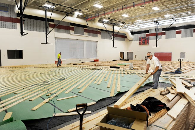 Installation of the gymnasium floor is under way at Hickory Grove Elementary School in the Dunlap school district. School officials plan to open the school to students for the first time Aug. 22 in a half-day session.