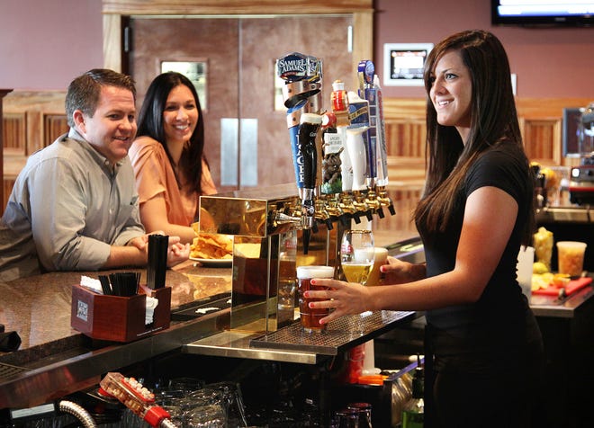 Bartender Meghan Cossette serves a lunch crowd at The Lodge.