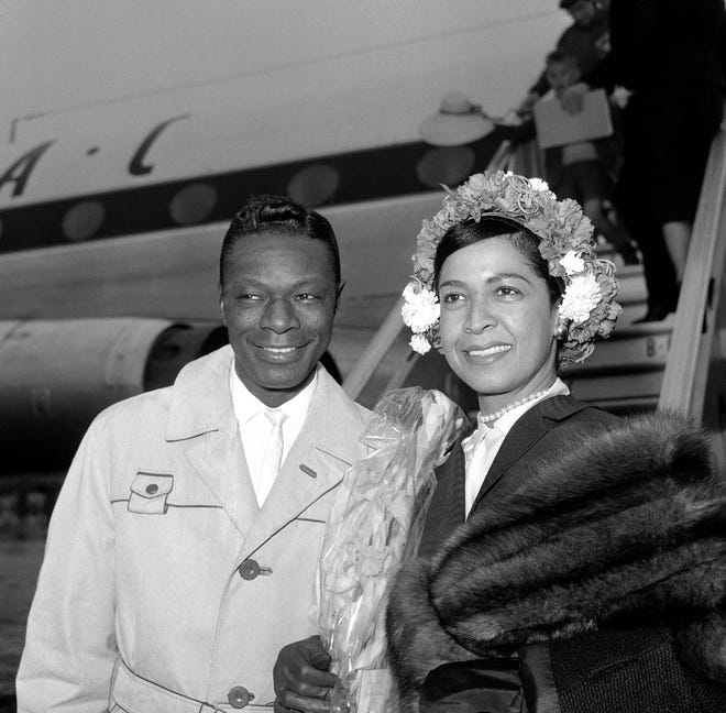 In this May 12, 1960, file photo, singer and jazz pianist Nat 'King' Cole and his wife, Maria Hawkins Cole, arrive at London Airport, United Kingdom, Maria Hawkins Cole, widow of Nat 'King' Cole and mother of Natalie Cole, has died on Tuesday in South Florida after a short battle with cancer. She was 89.