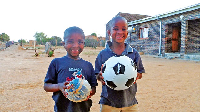 Two South African boys are all smiles showing off a new soccer ball given them by Taunton native and Peace Corps volunteer Kevin Crowninshield.
Photo by Kevin Crowninshield